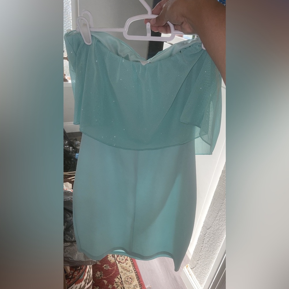 This is a mini Aqua dress that has a sparkling top attached to it .